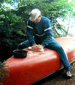 Bill kneading the bread dough. If your canoe is 'fiberglass', don't sit on it!